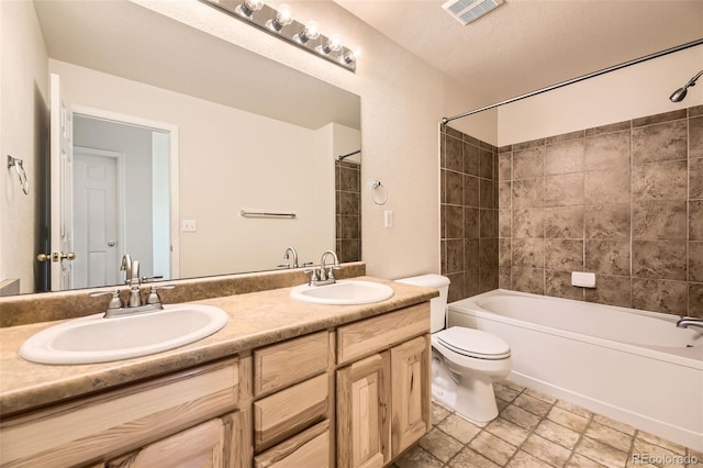 12704 Jasmine St Unit E, Thornton, CO 80602 - full bathroom with double vanity, shower / tub combination, and a textured ceiling