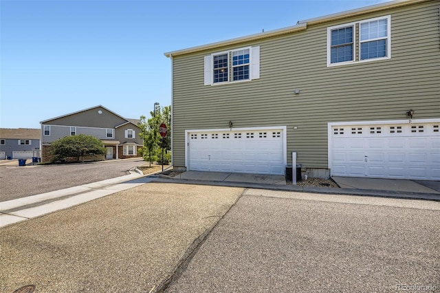 12704 Jasmine St Unit E, Thornton, CO 80602 - view of home's exterior with a garage and driveway