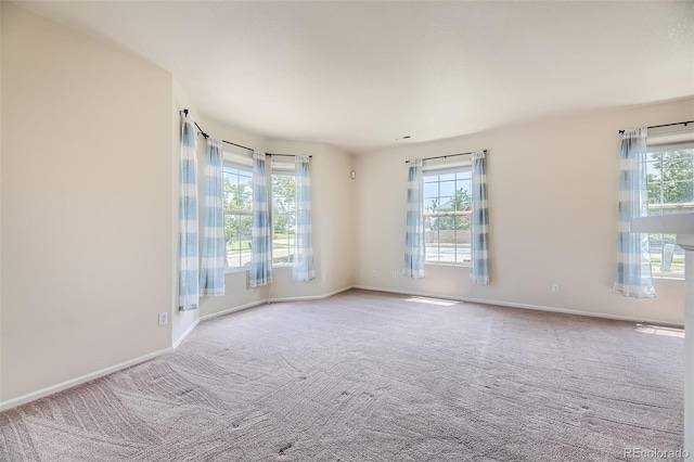 12704 Jasmine St Unit E, Thornton, CO 80602 - spare room with healthy amount of natural light and carpet flooring