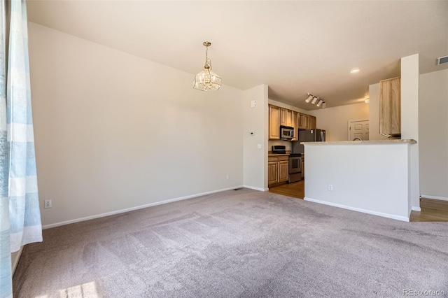 12704 Jasmine St Unit E, Thornton, CO 80602 - unfurnished living room with carpet floors and a chandelier