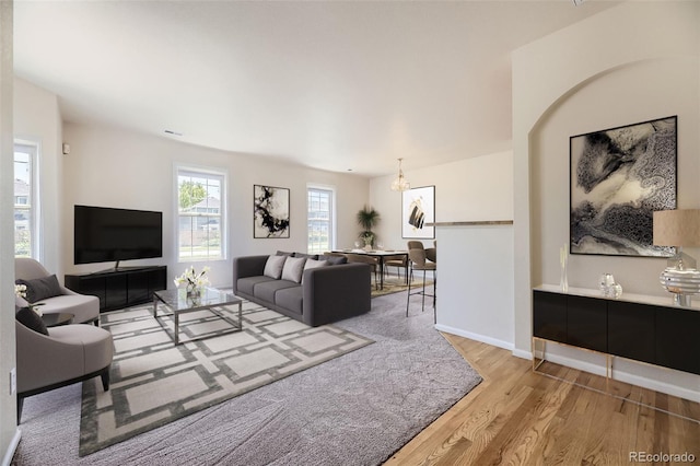 12704 Jasmine St Unit E, Thornton, CO 80602 - living room with wood finished floors and a chandelier