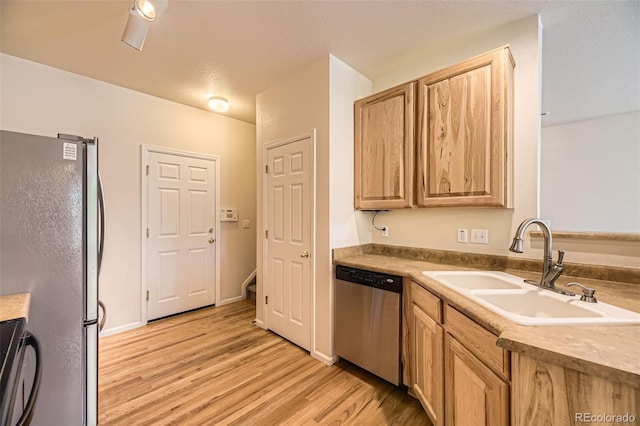 12704 Jasmine St Unit E, Thornton, CO 80602 - kitchen with appliances with stainless steel finishes and light wood-type flooring