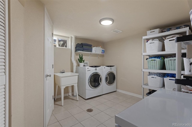 3300 Oneida St, Denver, CO 80207 - clothes washing area featuring laundry area, visible vents, baseboards, washer and clothes dryer, and light tile patterned floors