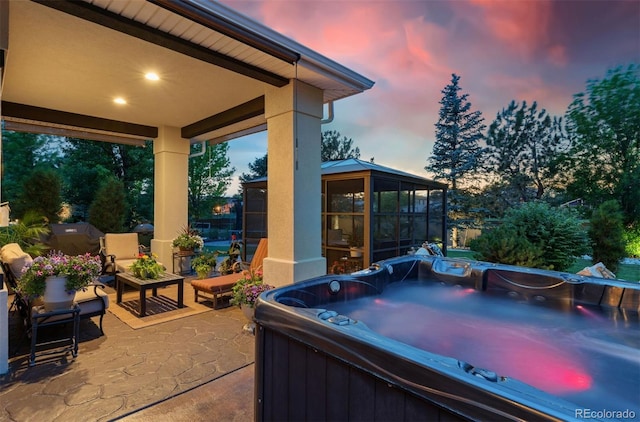 7 Sandpiper Cir, Thornton, CO 80241 - patio terrace at dusk featuring a hot tub, a patio, a sunroom, and grilling area