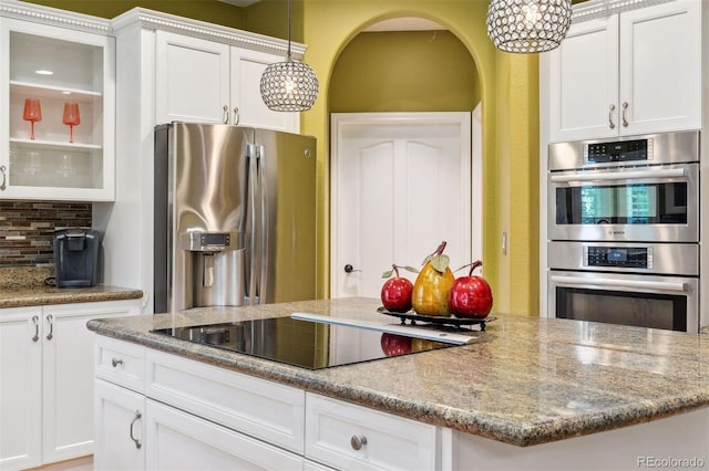 7 Sandpiper Cir, Thornton, CO 80241 - kitchen featuring stainless steel appliances, decorative backsplash, and white cabinets