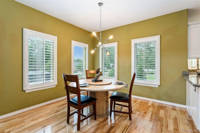 7 Sandpiper Cir, Thornton, CO 80241 - dining area with light wood-type flooring and a chandelier