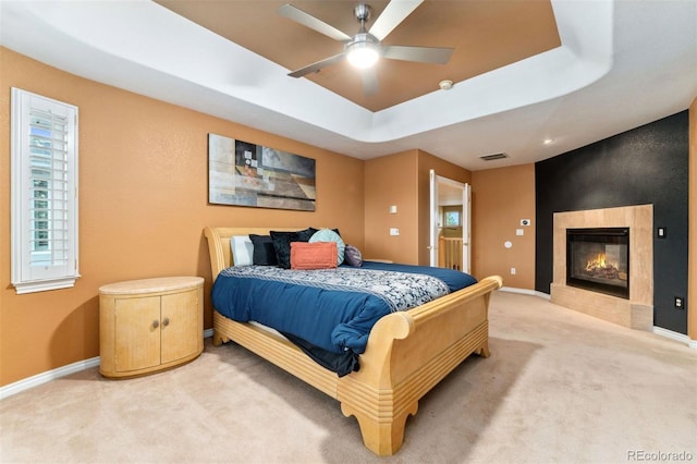 7 Sandpiper Cir, Thornton, CO 80241 - carpeted bedroom featuring a tray ceiling, a fireplace, and ceiling fan