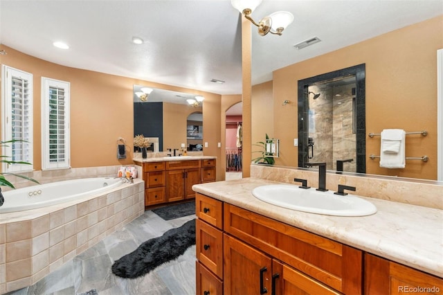 7 Sandpiper Cir, Thornton, CO 80241 - bathroom featuring a stall shower, two vanities, and a garden tub