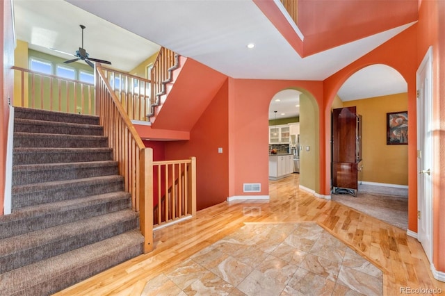 7 Sandpiper Cir, Thornton, CO 80241 - stairs with wood finished floors, arched walkways, a ceiling fan, and recessed lighting