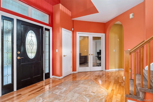 7 Sandpiper Cir, Thornton, CO 80241 - entryway featuring arched walkways, french doors, wood finished floors, and stairs