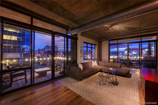 living room with expansive windows and wood-type flooring