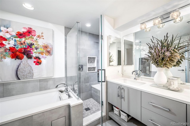 bathroom with separate shower and tub and vanity