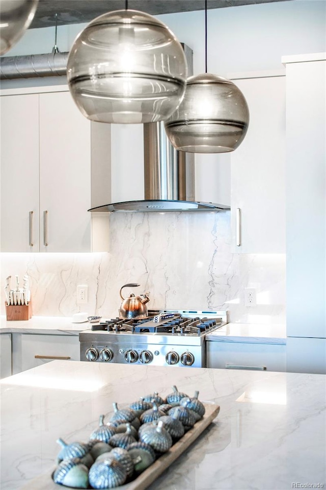 details featuring light stone counters, white cabinetry, backsplash, and extractor fan