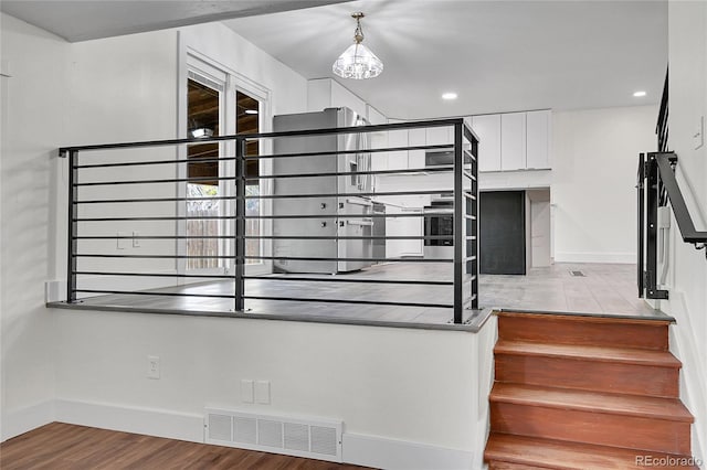 5419 E 113th Ave, Thornton, CO 80233 - staircase featuring wood finished floors, baseboards, a chandelier, and recessed lighting