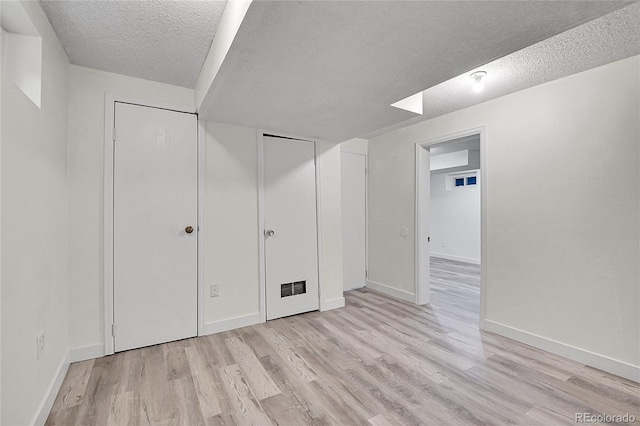 5419 E 113th Ave, Thornton, CO 80233 - unfurnished bedroom featuring a textured ceiling, light wood-style floors, baseboards, and a closet