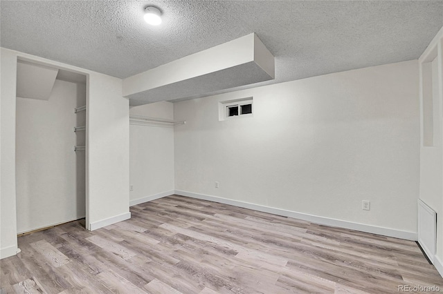 5419 E 113th Ave, Thornton, CO 80233 - finished basement featuring a textured ceiling, wood finished floors, and baseboards