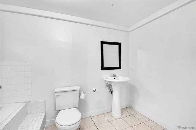 5419 E 113th Ave, Thornton, CO 80233 - full bathroom featuring toilet, tiled bath, tile patterned floors, baseboards, and a sink