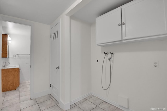 5419 E 113th Ave, Thornton, CO 80233 - laundry area featuring light tile patterned floors, hookup for a washing machine, electric dryer hookup, and cabinet space