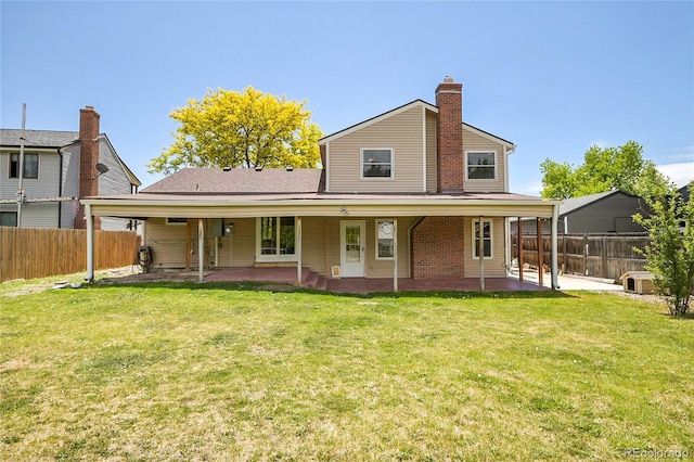 5419 E 113th Ave, Thornton, CO 80233 - back of property featuring a patio, a chimney, and brick siding