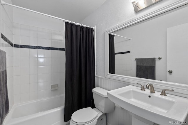 full bathroom with shower / bath combo, toilet, and sink