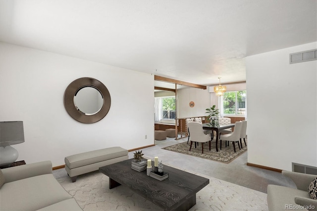 352 S Peoria Cir, Aurora, CO 80012 - carpeted living room featuring baseboards and a chandelier