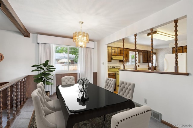 352 S Peoria Cir, Aurora, CO 80012 - dining area featuring a chandelier and beam ceiling