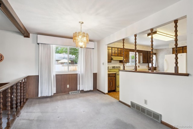 352 S Peoria Cir, Aurora, CO 80012 - unfurnished dining area featuring a chandelier, healthy amount of natural light, light carpet, and beamed ceiling