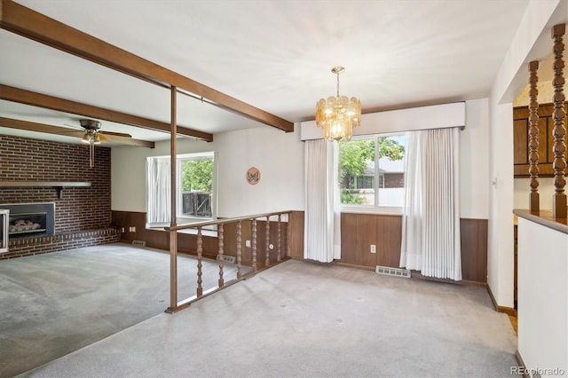 352 S Peoria Cir, Aurora, CO 80012 - unfurnished living room with carpet flooring, healthy amount of natural light, a ceiling fan, a chandelier, and a wainscoted wall