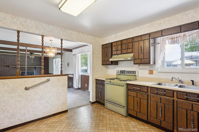 352 S Peoria Cir, Aurora, CO 80012 - kitchen featuring electric range oven, under cabinet range hood, wallpapered walls, light countertops, and light floors