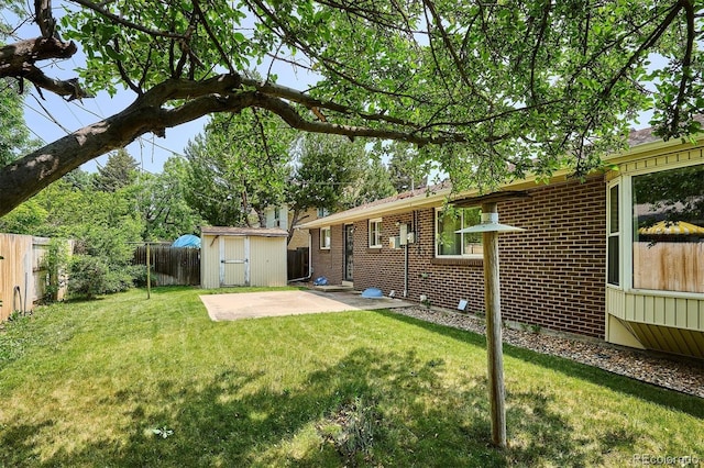352 S Peoria Cir, Aurora, CO 80012 - rear view of house with a fenced backyard, a shed, a patio, and brick siding