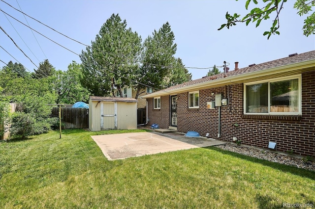 352 S Peoria Cir, Aurora, CO 80012 - back of property with brick siding, a shed, and a patio