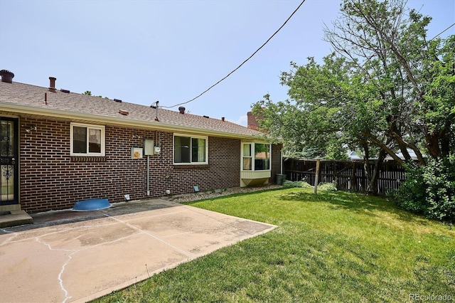 352 S Peoria Cir, Aurora, CO 80012 - back of property featuring a patio, brick siding, and a chimney