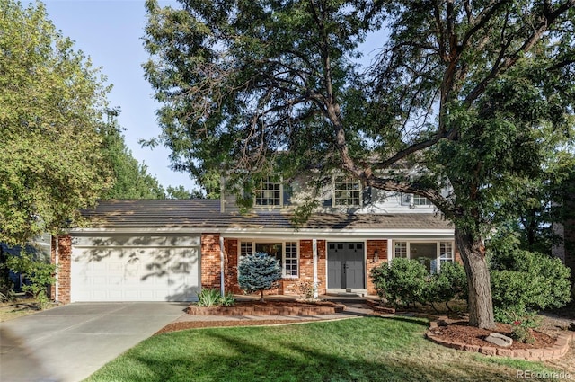 view of front of home with a garage and a front lawn