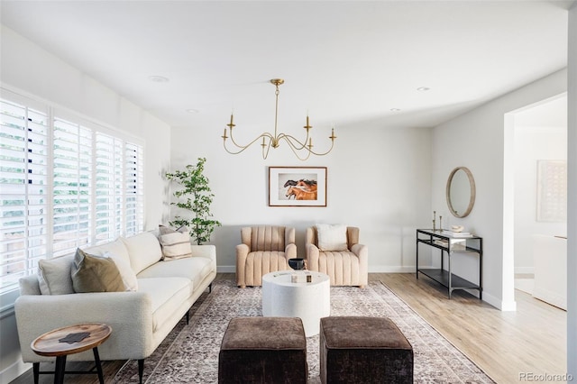 living room with a notable chandelier and wood-type flooring