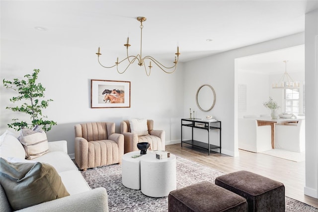 living room with a notable chandelier and hardwood / wood-style flooring