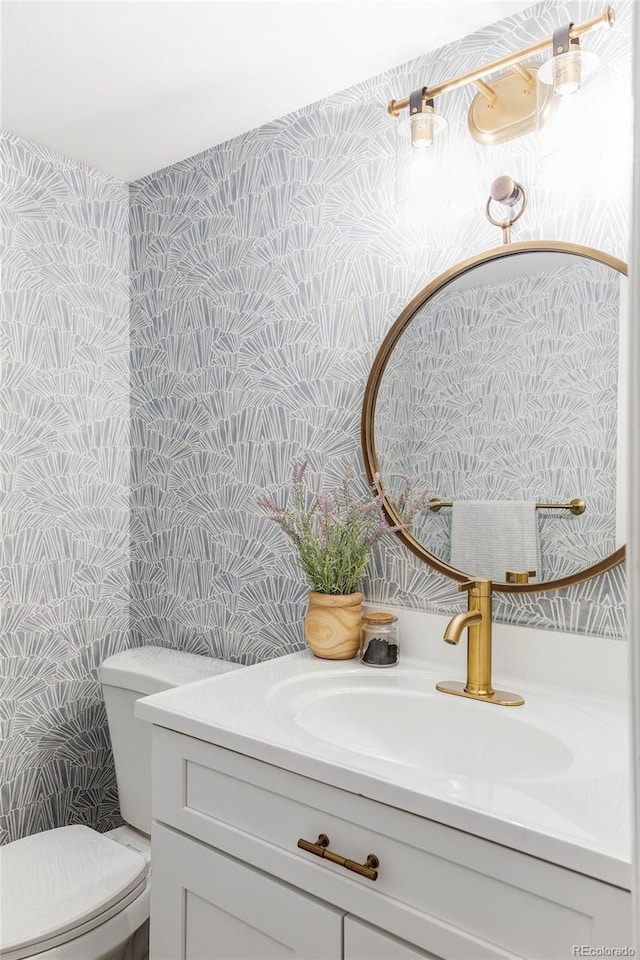 bathroom featuring toilet and vanity