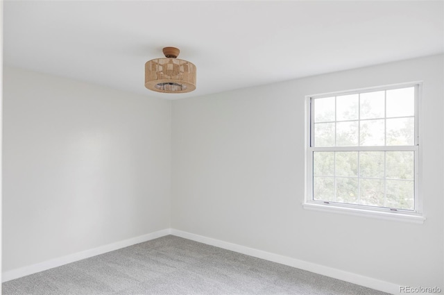 carpeted spare room featuring a wealth of natural light