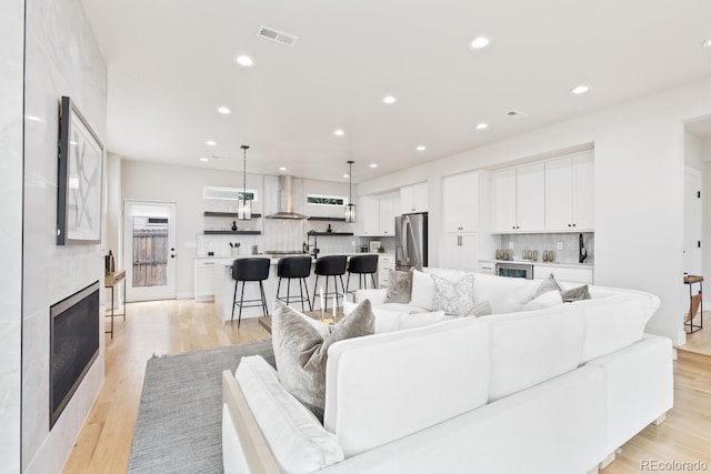 2040 W 45th Ave, Denver, CO 80211 - living room featuring recessed lighting, a fireplace, light wood-style floors, and beverage cooler
