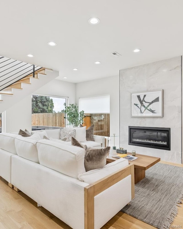 2040 W 45th Ave, Denver, CO 80211 - living area featuring light wood-style flooring, a fireplace, recessed lighting, and stairway