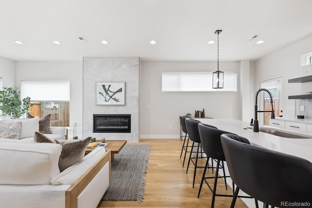 2040 W 45th Ave, Denver, CO 80211 - living area with light wood-style flooring, a fireplace, and recessed lighting