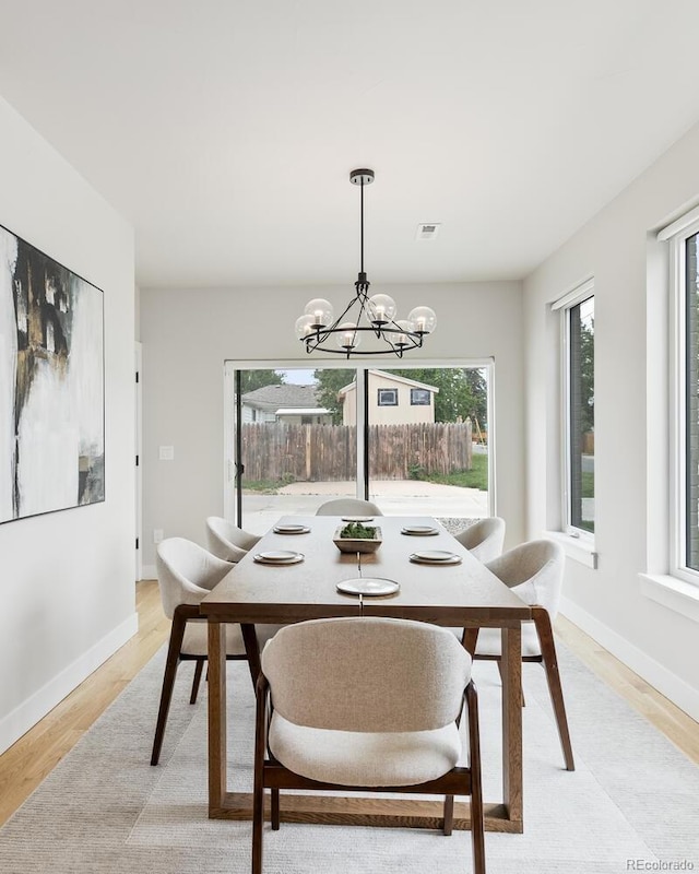 2040 W 45th Ave, Denver, CO 80211 - dining room featuring light wood-style flooring and a chandelier