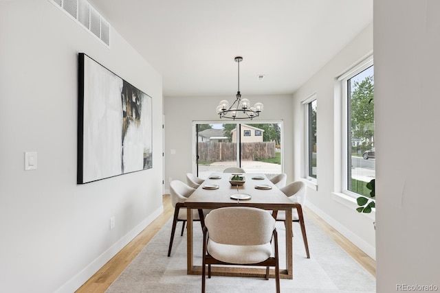 2040 W 45th Ave, Denver, CO 80211 - dining space featuring light wood-style floors and a chandelier