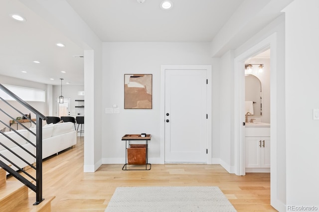 2040 W 45th Ave, Denver, CO 80211 - entrance foyer with stairs, light wood finished floors, recessed lighting, and arched walkways