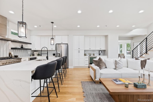 2040 W 45th Ave, Denver, CO 80211 - living area featuring light wood-type flooring, recessed lighting, stairs, and beverage cooler