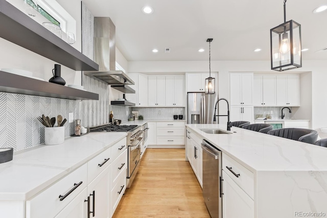 2040 W 45th Ave, Denver, CO 80211 - kitchen with range hood, stainless steel appliances, open shelves, light wood finished floors, and decorative backsplash