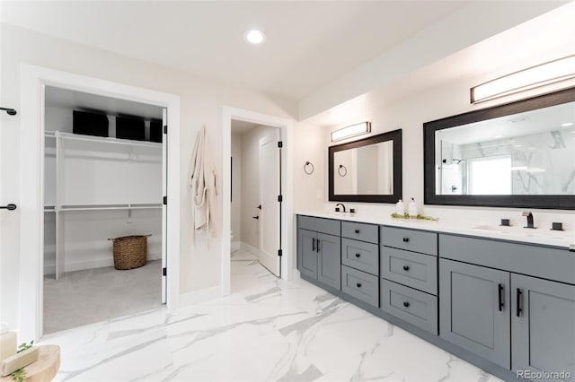 2040 W 45th Ave, Denver, CO 80211 - bathroom with double vanity, marble finish flooring, a walk in closet, a marble finish shower, and recessed lighting