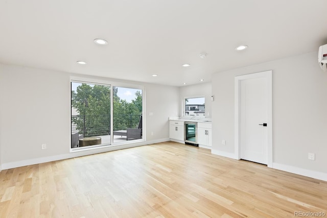 2040 W 45th Ave, Denver, CO 80211 - unfurnished living room featuring wine cooler, light wood-type flooring, and recessed lighting