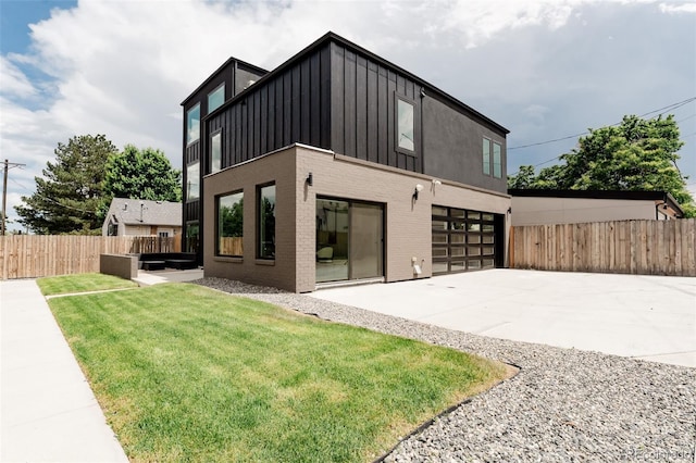 2040 W 45th Ave, Denver, CO 80211 - back of house with concrete driveway, board and batten siding, a garage, and brick siding
