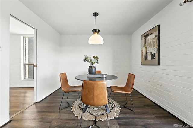 460 S Marion Pkwy Unit 801, Denver, CO 80209 - dining area featuring dark wood finished floors and brick wall