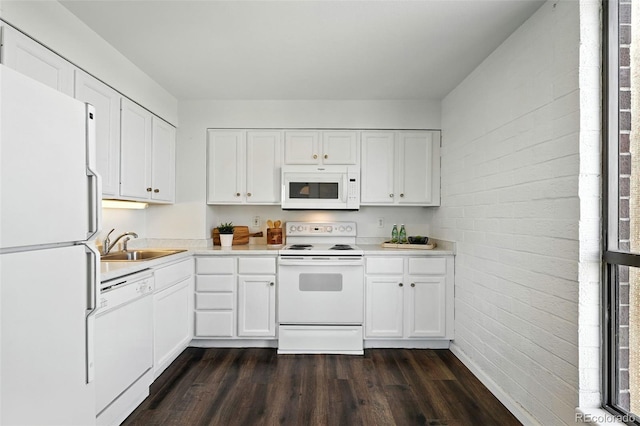 460 S Marion Pkwy Unit 801, Denver, CO 80209 - kitchen with white appliances, dark wood-type flooring, light countertops, brick wall, and white cabinetry